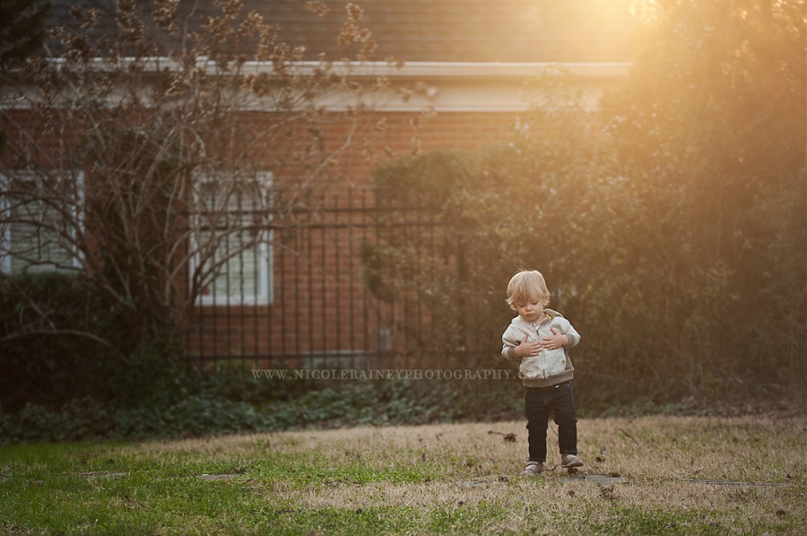 Little-Boy-Playing-in-a-Wash-of-Golden-Light-in-Yard-by-Nikki-Rainey