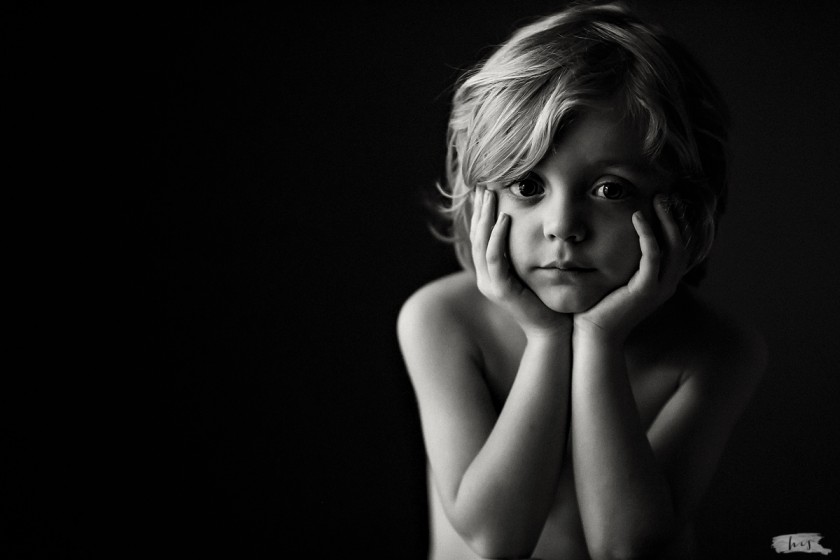 simple portrait of boy with his head in his hands by Heather Stockett