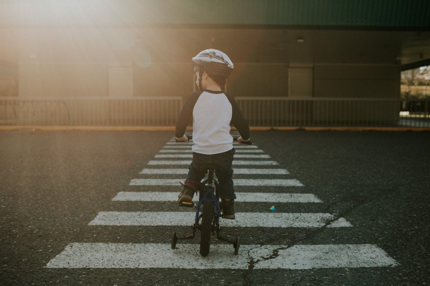 boy riding his bike with a helmet on by Cassandra McCasley of Twist and Shutter Photography