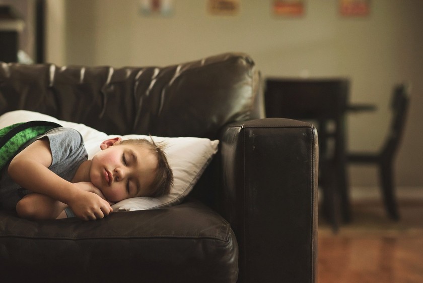 photo of boy sleeping on the couch by Brittany Blake