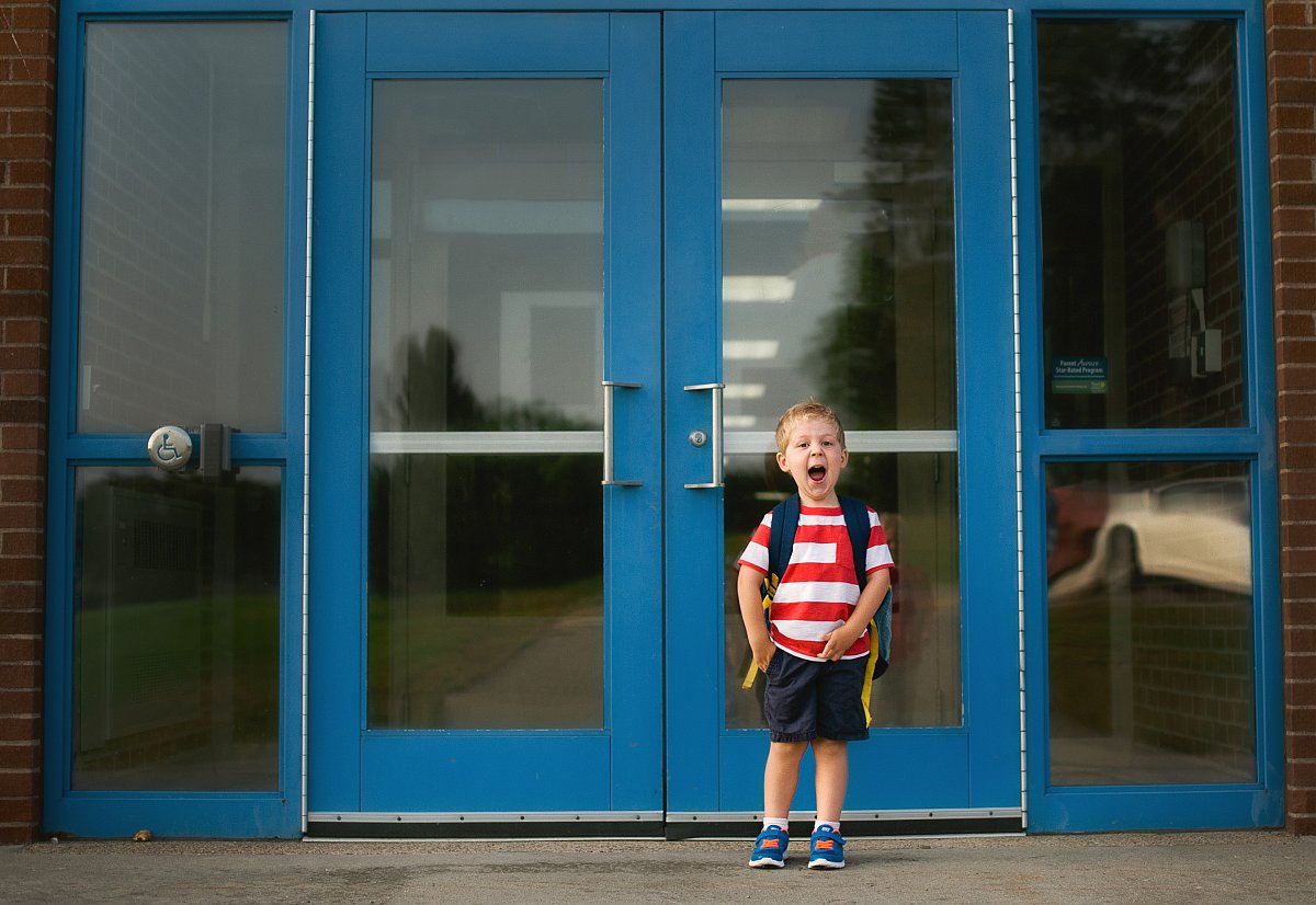 colorful photo of little boy on the first day of schoold by Beth Mancuso