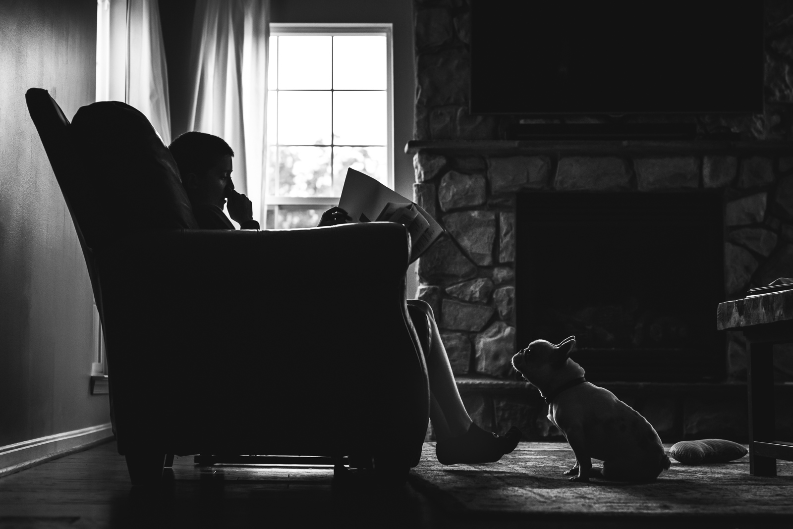 black and white photo of dog watching boy read by Jennifer Nobriga