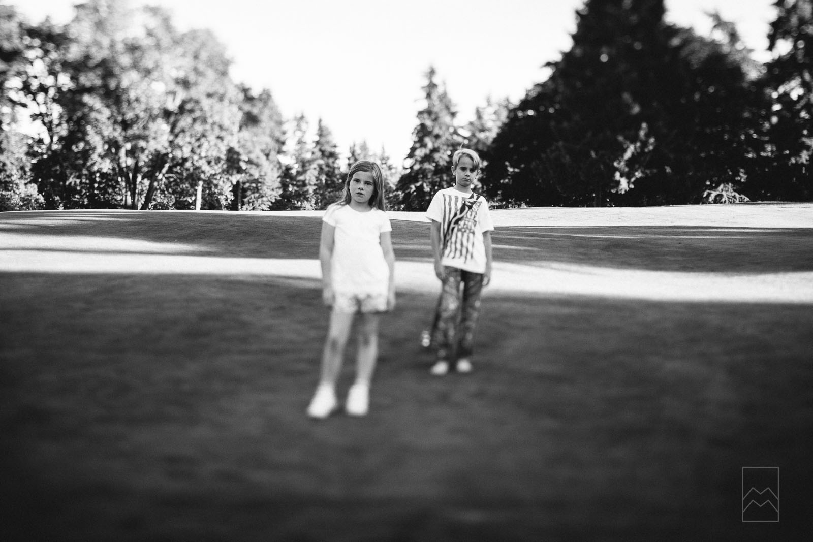 black-and-white-photo-of-two-kids-with-a-tilt-shift-lens-by-meghan-mcmackin