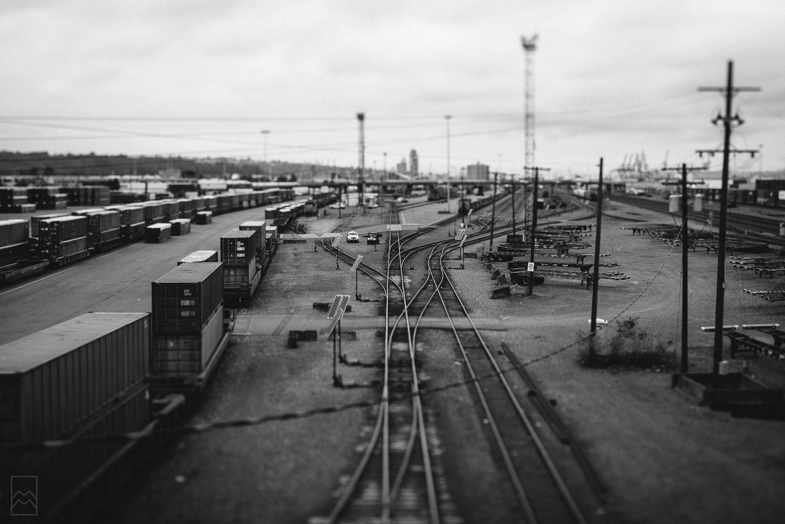 black and white tilt-shift photo of train tracks to look miniature by Meghan McMackin