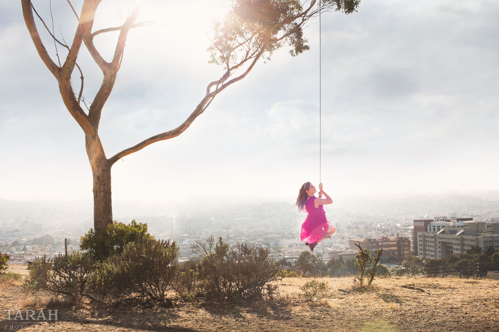 photo of girl on a swing overlooking San Francisco by Tarah Beaven