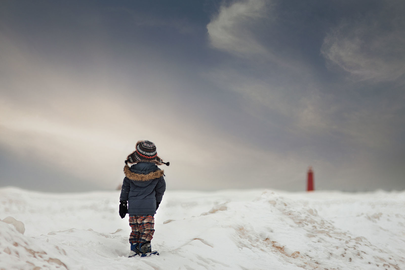 photo of boy walking on the snow by Meg Loeks