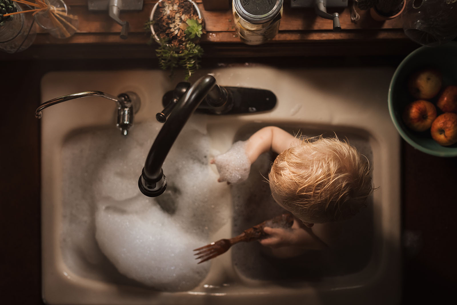 picture of boy taking a sink bath by Meg Loeks