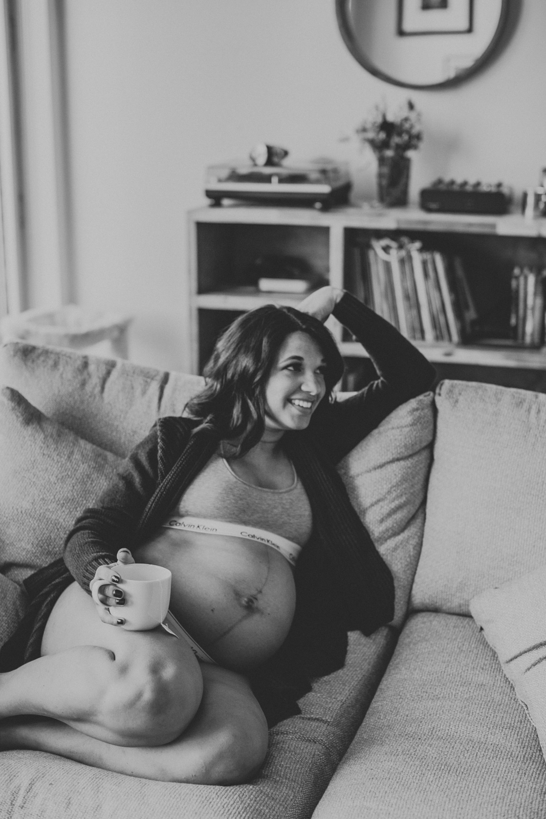 lifestyle intimate boudoir maternity photography mom relaxing on sofa in calvin klein underwear amy hanen
